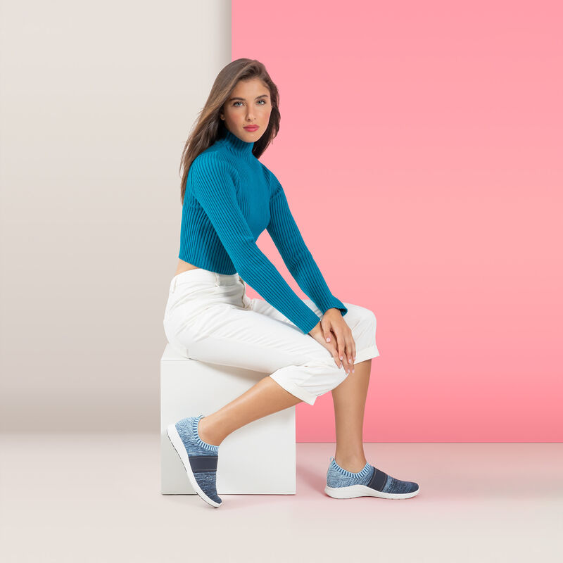 woman wearing blue stretchy knit sneaker
